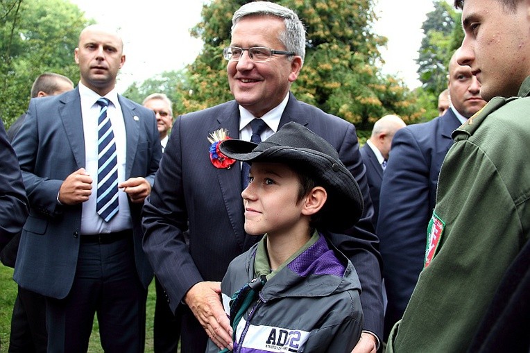 Prezydent Komorowski pozuje do zdjęcia z młodym harcerzem