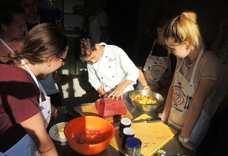 Filetowanie tuńczyka - wszyscy patrzą w skupieniu na mlodego masterchefa