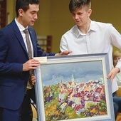 ▲	Wśród darów znalazł się obraz przedstawiający panoramę Olsztyna. Wylicytował go europoseł prof. Karol Karski.