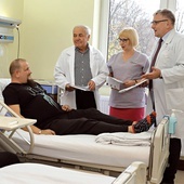 Od lewej: prof. Lech Poloński, oddziałowa Krystyna Czapla i prof. Mariusz Gąsior w rozmowie z pacjentem.
