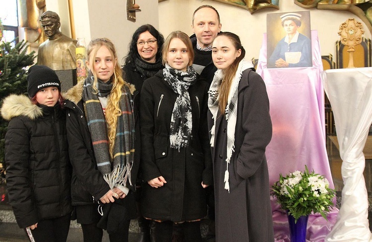 Rodzina Małgorzaty i Krzysztofa Wydrów przy relikwiach bł. Hanny.