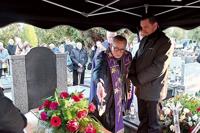 	Ksiądz Piotr Mrzygłód w czasie ceremonii pogrzebowej na cmentarzu.