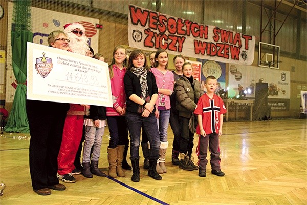  Turniej charytatywny „Gwiazdy na Gwiazdkę” w Łowiczu. Elżbieta Błaszczyk z symbolicznym czekiem w otoczeniu swoich podopiecznych