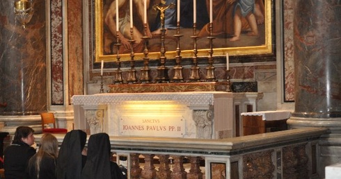 Pielgrzymi na modlitwie przy ołtarzu w bazylice watykańskiej, gdzie spoczywają relikwie św. Jana Pawła II