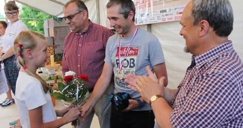 Trener Łukasz Kruczek (w środku) odebrał złoty medal i kwiaty od organizatorów IV Mini Olimpiady