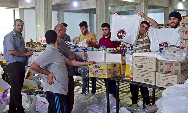 Ankawa obok Erbilu w Iraku. Chrześcijańskie rodziny wygnane z Mosulu i Niniwy odbierają paczki żywnościowe