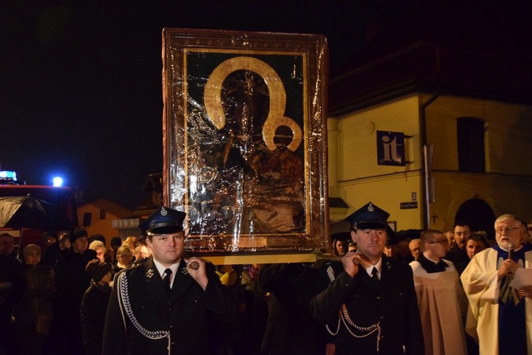 Strażacy niosą obraz Matki Bożej w procesji do sanktuarium