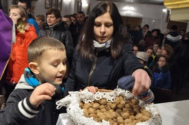 Uczestnicy liturgii zabierają pobłogosławione orzechy do domu