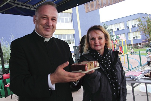 ▲	 Zwyciężczyni licytacji tortu – Joanna Szmuc z ks. Janem Biedroniem i… wylicytowanym ciastem.