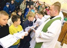 ◄	Obrzęd przyjęcia do grona ministrantów kończy nałożenie poświęconego stroju.