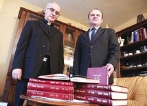 Ks. Jan Nowakowski i Marek Gruca przy zarchiwizowanych w tomy egzemplarzach „Głosu Parafii”.