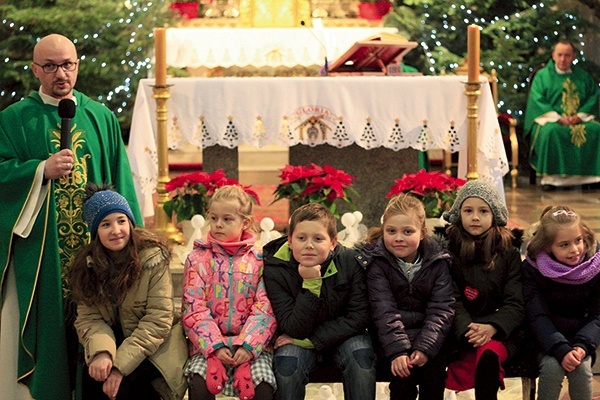 ▼	Jezuita z dziećmi podczas Mszy Świętej.