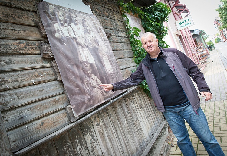 Krzysztof Skibiński przy swojej fotografii z dzieciństwa na budynku przy ul. Krótkiej.