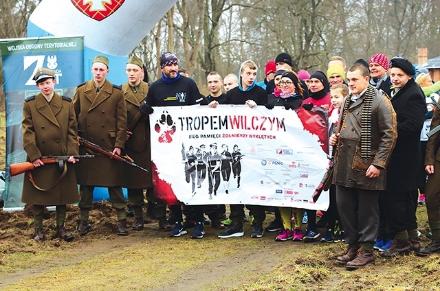 Uczestnicy Biegu Tropem Wilczym wraz z rekonstruktorami.