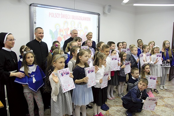 ▲	Tradycją konkursów plastycznych jest wspólna fotografia. Stoją od lewej: s. Julia Kalarus CFS, ks. Sławomir Molendowski, ks. Stanisław Łabendowicz  i Ewa Majcher.