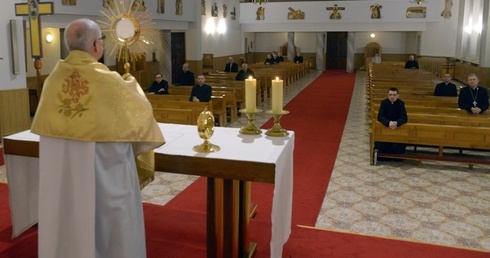 Kapłani obecni na wieczornym nabożeństwie otrzymują błogosławieństwo Najświętszym Sakramentem.