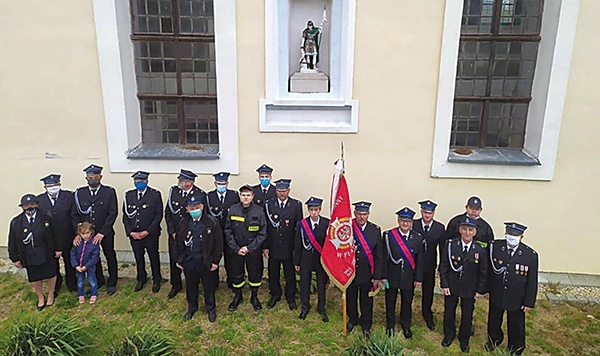 Strażacy z OSP Platerówka pod figurą św. Floriana.