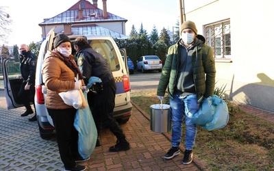 Streetworkerzy ze Strażą Miejską rozwożą gorące posiłki bezdomnym.