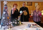 Panie Genowefa Mądra (z prawej) i Marianna Sieczkowska z ks. Gabrielem Marciniakiem prezentują świąteczne ozdoby.