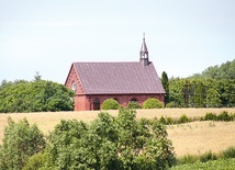 ▲	Kościółek w Karwosiekach widoczny ze wzgórza, na którym znajduje się cmentarz.