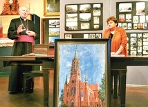 ▲	Otwarcie wystawy. Maria Solarz, ks. Ryszard Sorota  i jeden z wielu obrazów z wizerunkiem bazyliki.