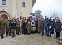 Uczestnicy przed tablicą informacyjną.