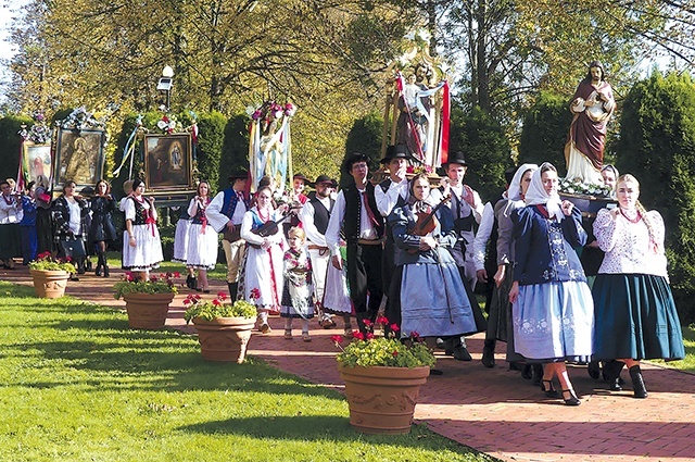 	Parafianie podczas procesji eucharystycznej wokół zabytkowej świątyni.