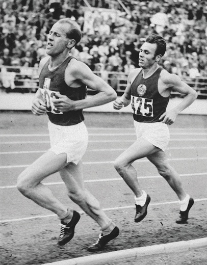 Emil Zátopek biegnie po złoto  na 5000 metrów. Za nim Rosjanin Aleksandr Anufriew.