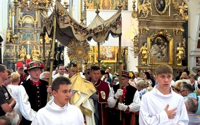 W Łowiczu wierni wychodzą za Najświętszym Sakramentem z bazyliki katedralnej.