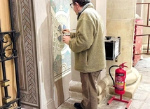 Prof. Sylwester Piędziejewski pracuje przy malowidłach na tylniej ścianie świątyni na Tumskim Wzgórzu.